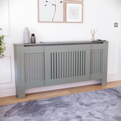 Adjustable Chelsea radiator cover in olive grey with a decorative slatted front.
