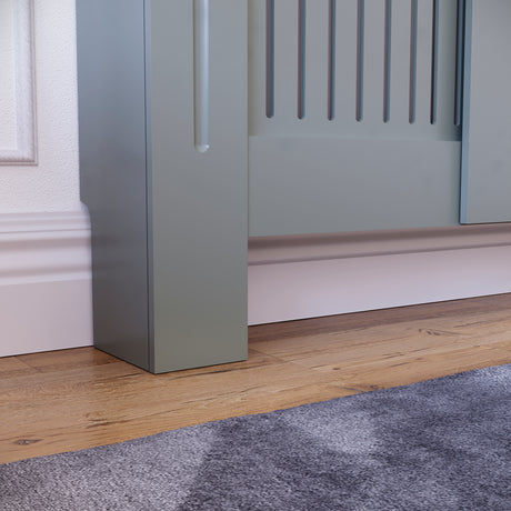 Adjustable Chelsea radiator cover in olive grey with a decorative slatted front.
