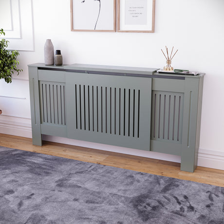 Adjustable Chelsea radiator cover in olive grey with a decorative slatted front.
