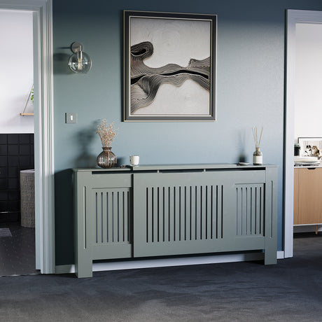 Adjustable Chelsea radiator cover in olive grey with a decorative slatted front.
